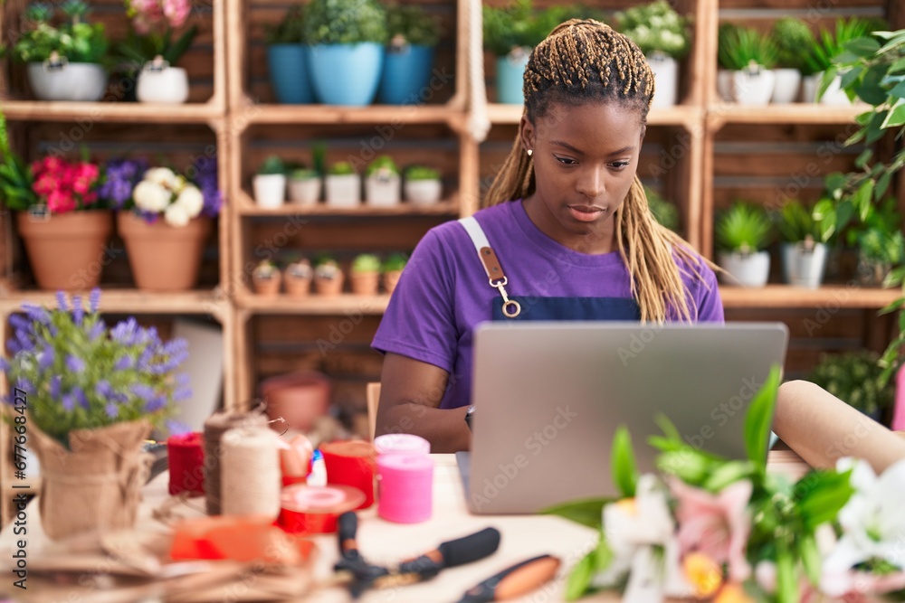 African american woman florist using laptop at florist African american woman florist using laptop at florist