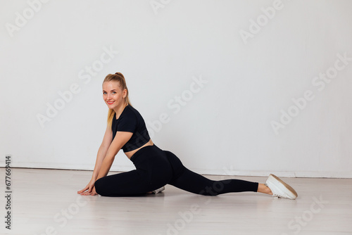 woman in black tracksuit exercise sport in the gym warm-up exercises