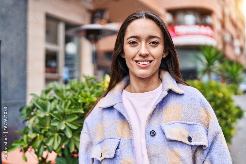 Young beautiful hispanic woman smiling confident standing at street