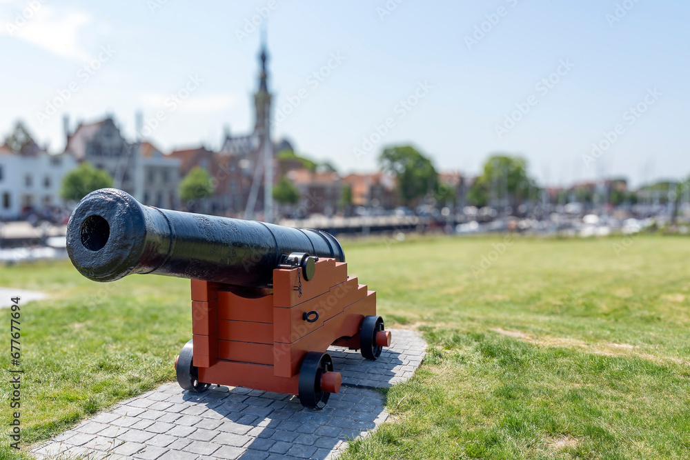 An old cannon on top of the city wall in front of the marina of Veere, Zeeland An old cannon on top of the city wall in front of the marina of Veere, Zeeland