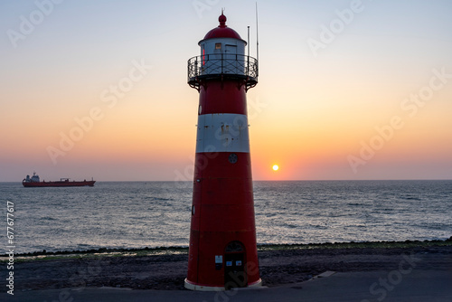 A freighter passes Lighthouse Noorderhoofd near Westkapelle