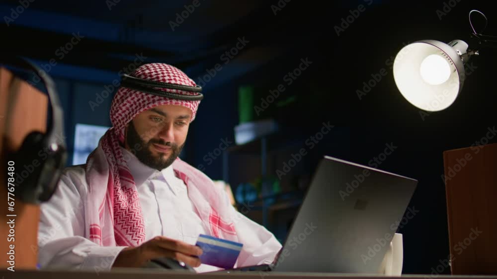 Happy arab man doing internet shopping on computer, spneding money on frivolous things. Smiling Middle Eastern person adding payment method on website in order to purchase products Happy arab man doing internet shopping on computer, spneding money on frivolous things. Smiling Middle Eastern person adding payment method on website in order to purchase products