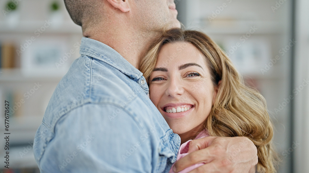 Man and woman couple hugging each other smiling at home Man and woman couple hugging each other smiling at home