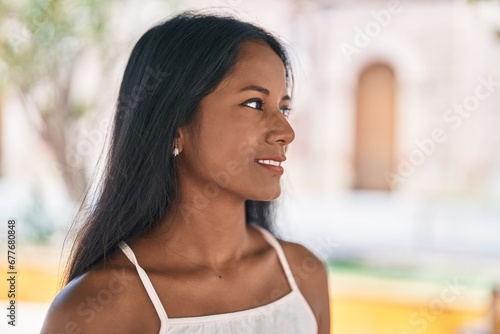 Young beautiful woman smiling confident looking to the side at park