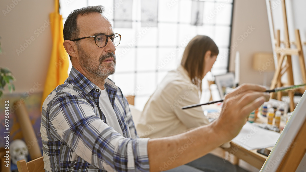 In an art studio, two focused artists - a man and woman, intently draw on canvas, deepening their bond and igniting creativity