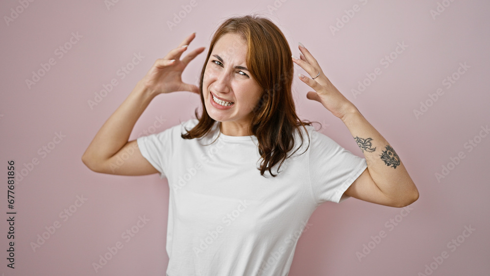 Young woman screaming loudly over isolated pink background