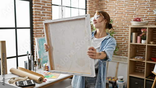 Young woman artist smiling confident looking draw at art studio