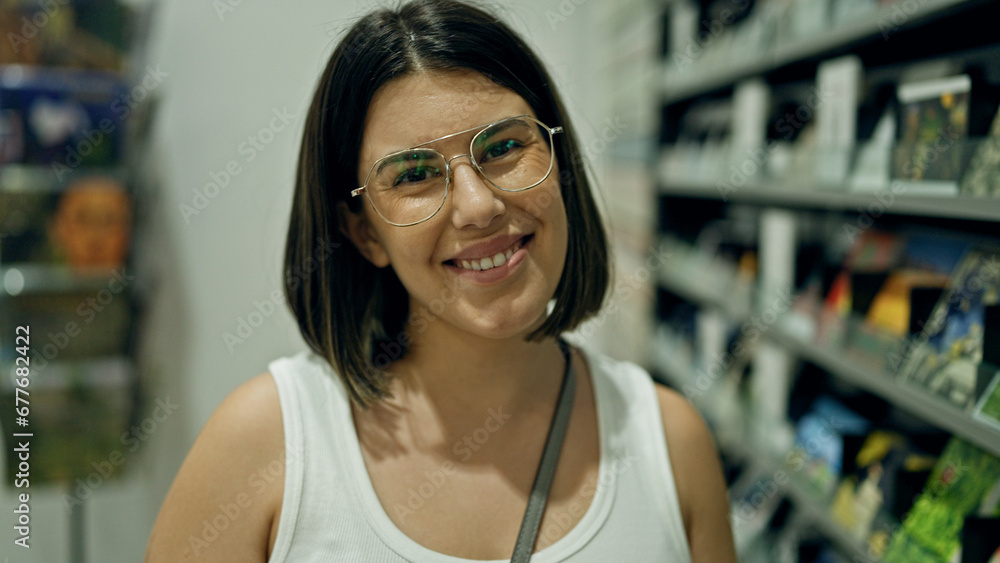 Young beautiful hispanic woman smiling confident standing at souvenirs shop Young beautiful hispanic woman smiling confident standing at souvenirs shop