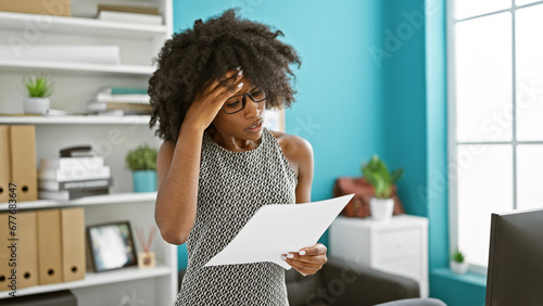 African american woman business worker reading document at the office