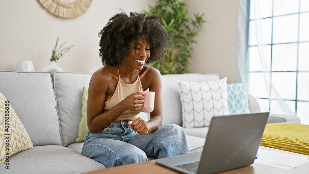 African american woman having video call drinking coffee at home African american woman having video call drinking coffee at home