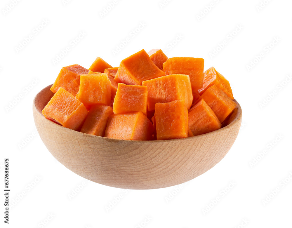 dice carrots in a wooden bowl isolated on a white background. Carrot cubes.