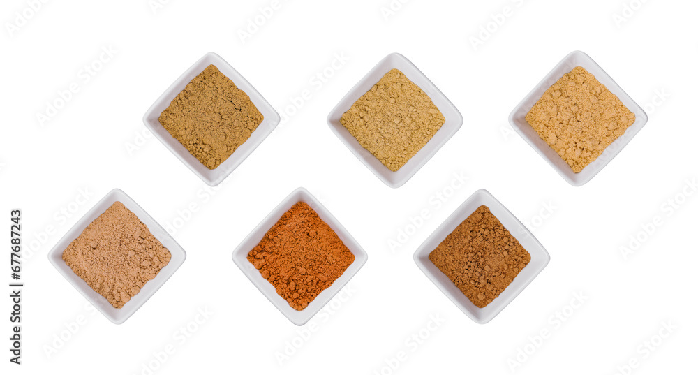 Fototapeta premium Various Indian Spices in Small White Bowls on white background