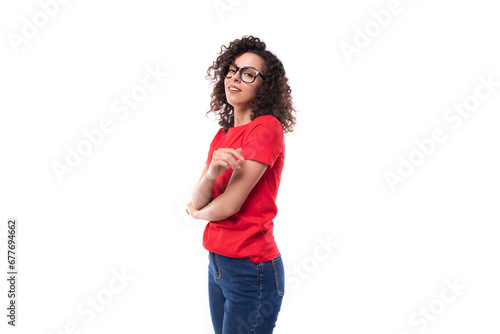 portrait of slim young pretty curly brunette woman wearing casual basic red t-shirt with mockup