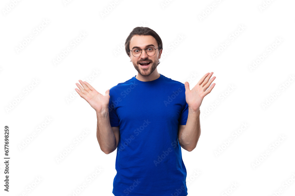 young smart confident caucasian brunette man with a beard in a blue t-shirt on a white background young smart confident caucasian brunette man with a beard in a blue t-shirt on a white background