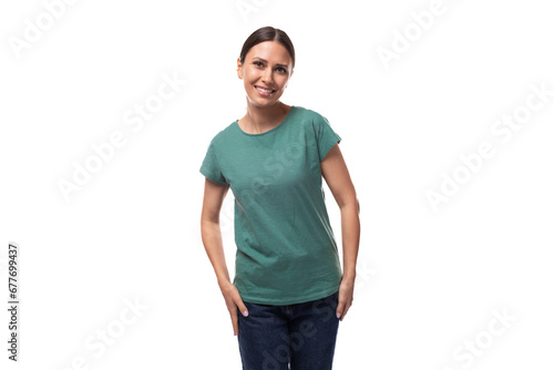 young slender european woman with a ponytail hairstyle is dressed in a green t-shirt smiling cutely © Ivan Traimak