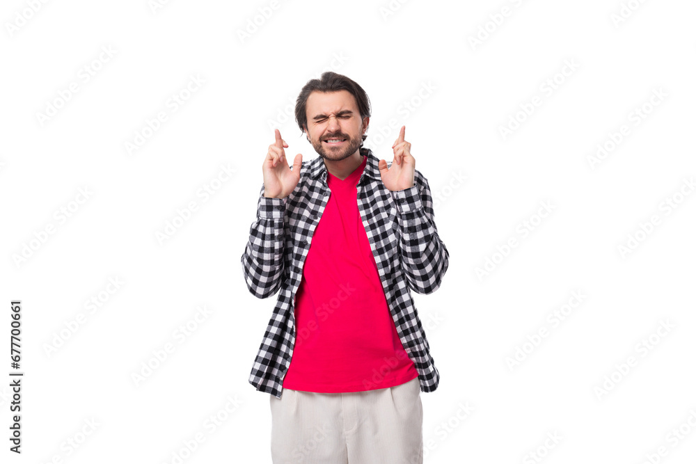 surprised brutal young european man with black hair and a beard in a shirt on a white background with copy space surprised brutal young european man with black hair and a beard in a shirt on a white background with copy space