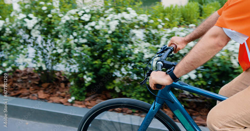 Fototapeta premium Happy bearded caucasian bearded man in headphone and sunglasses using smartphone while walking with bike at urban area. Commute work sustainable lifestyle in the city.