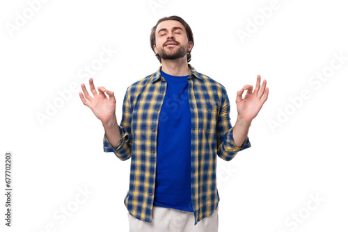 portrait of a pleasant calm young european brunette with a beard dressed stylishly in a shirt