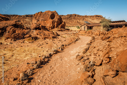 Twyfelfontein Visitor Center surrounded by red sandstone cliffs, Kunene, Namibia. This UNESCO World Heritage site boasts the largest concentration of rock art engravings in southern Africa.