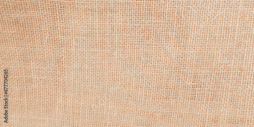Cream abstract Hessian or sackcloth fabric or hemp sack texture background. Wallpaper of artistic wale linen canvas. Blanket or Curtain of cotton pattern with space for text decoration. Light pattern.
