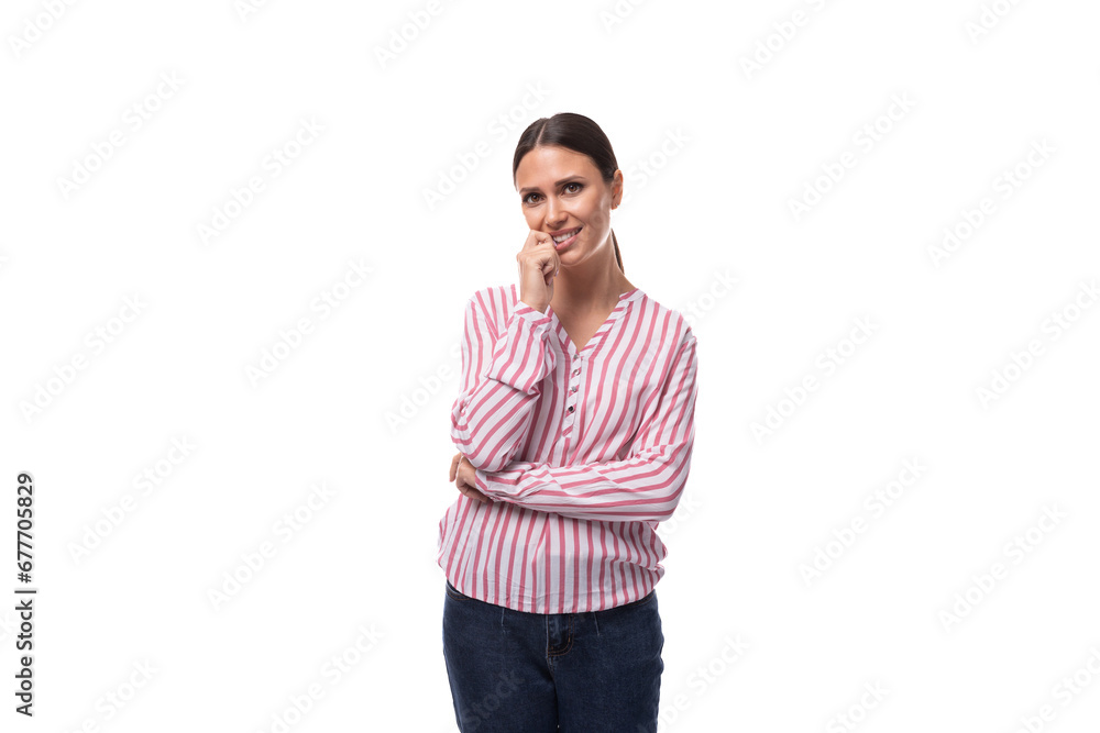 young well-groomed brunette assistant woman with a ponytail hairstyle is dressed in a striped blouse and jeans young well-groomed brunette assistant woman with a ponytail hairstyle is dressed in a striped blouse and jeans
