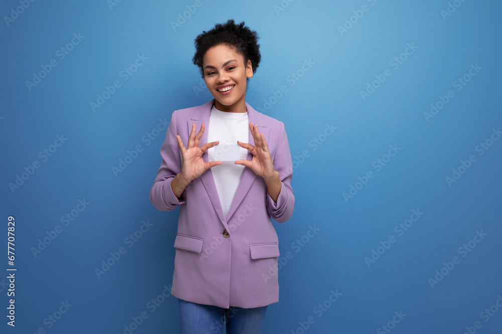 young latin business woman with ponytail hairstyle dressed in purple jacket on studio background with copy space young latin business woman with ponytail hairstyle dressed in purple jacket on studio background with copy space