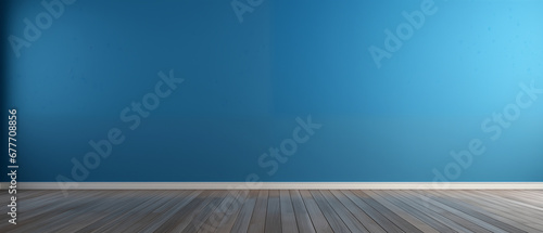 interior with an empty blue wall and wooden floor