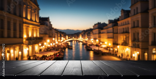 empty black wood surface with blurred historic cityscape at dusk; best for tourism marketing.