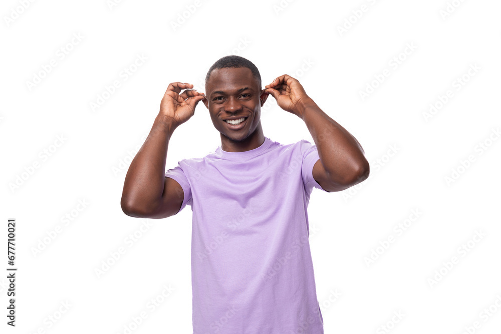 young authentic american guy dressed in a light lilac t-shirt on a white background young authentic american guy dressed in a light lilac t-shirt on a white background