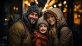 Close-up Portrait of an happy couple with his young smiling daughter with a blurry night street with lights in background
