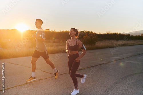 A handsome young couple running together during the early morning hours, with the mesmerizing sunrise casting a warm glow, symbolizing their shared love and vitality