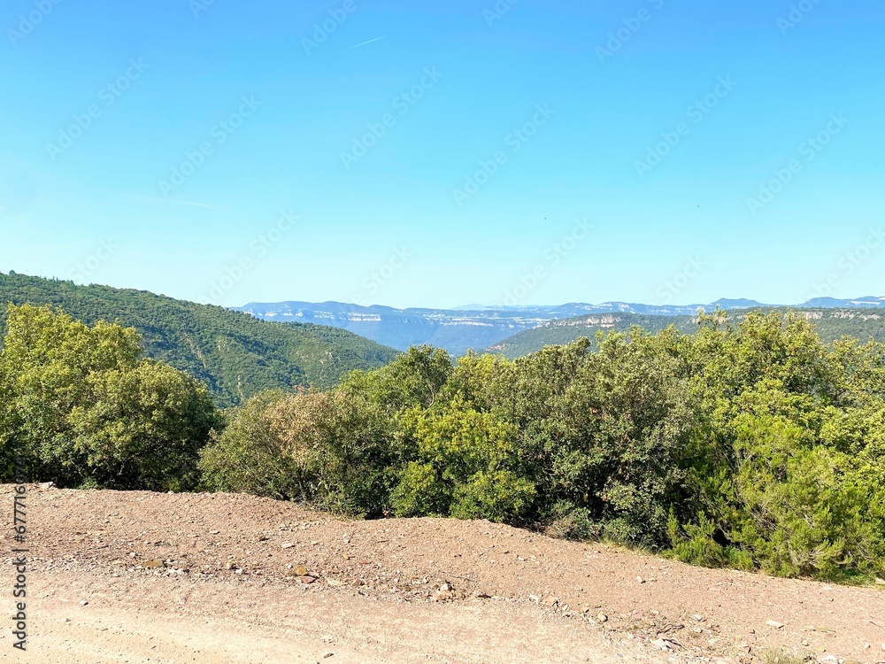 Dirt trail through a rural green field with trees in Catalonia, Spain Dirt trail through a rural green field with trees in Catalonia, Spain