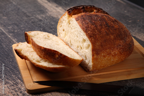 fresh round bread sliced on a board