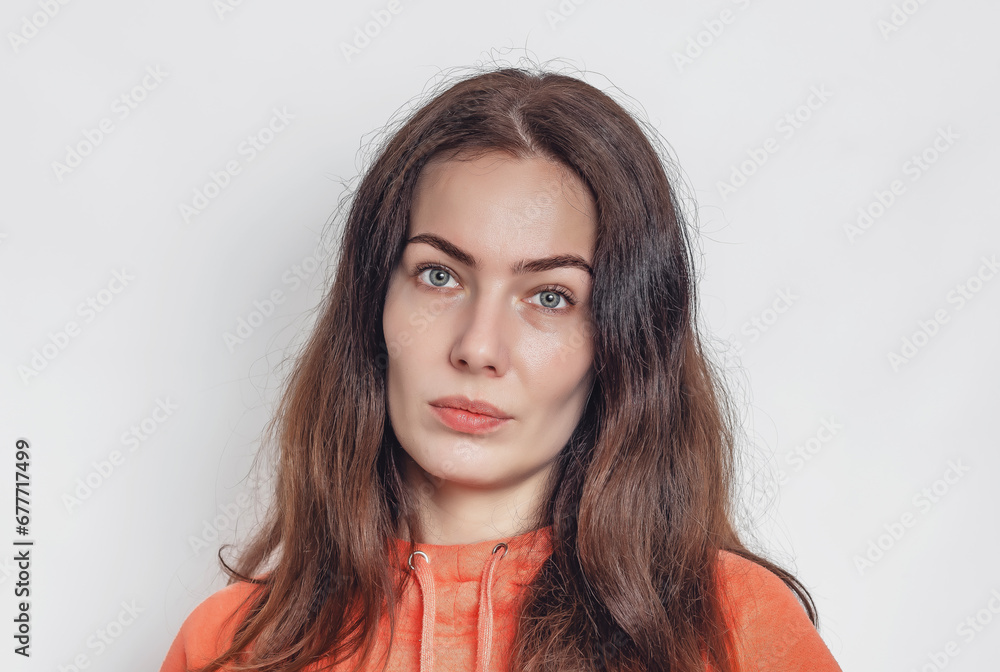 Face young woman black eyebrows blue eyes close-up. Makeup. Calm facial expression.