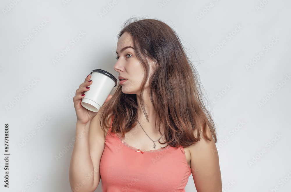 Charming woman with a dreamy look is drinking coffee. Studio quality photo. Charming woman with a dreamy look is drinking coffee. Studio quality photo.
