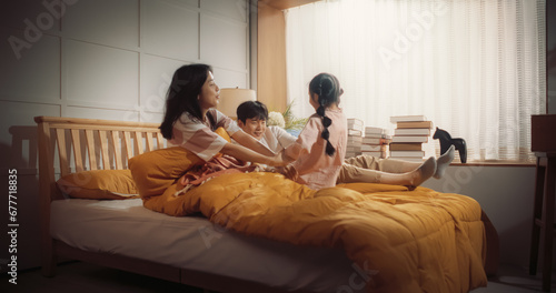 Photography Happy Korean Family in the Morning: Active and Playful Child Running to her Parents' Bedroom to Wake Them Up