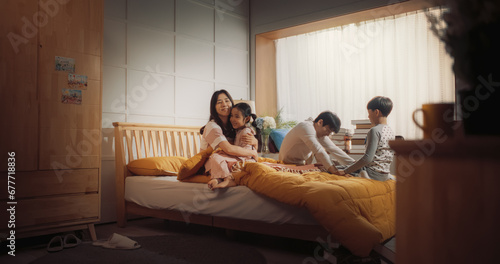 Fotografie Active and Playful Children Waking Their Parents Up to Face a New Day