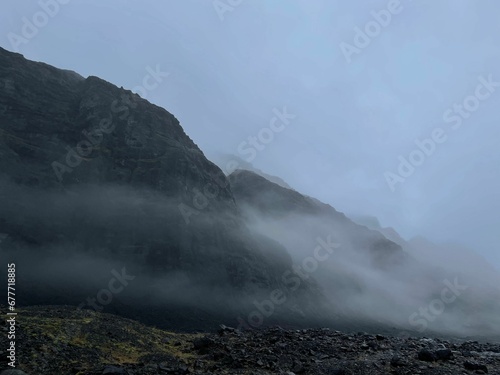 Scenic view of the fog covering rocky mountains