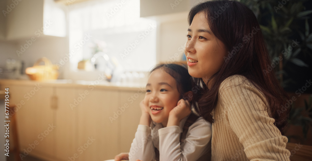 Portrait of a Korean Mother and her Little Daughter Participating in a Conversation at Home. Family Gathered Together, Bonding, Talking, Discussing, Sharing Stories on a Happy Weekend Morning Portrait of a Korean Mother and her Little Daughter Participating in a Conversation at Home. Family Gathered Together, Bonding, Talking, Discussing, Sharing Stories on a Happy Weekend Morning