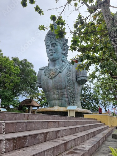Vertical shot of a giant statue of Vishnu in the Garuda Wisnu Kencana Cultural Park in Bali.