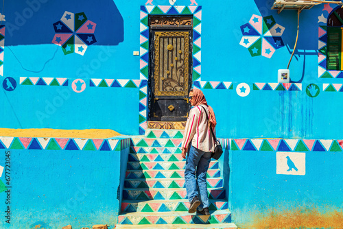 Woman tourist walks through the famous Nubian village. photo