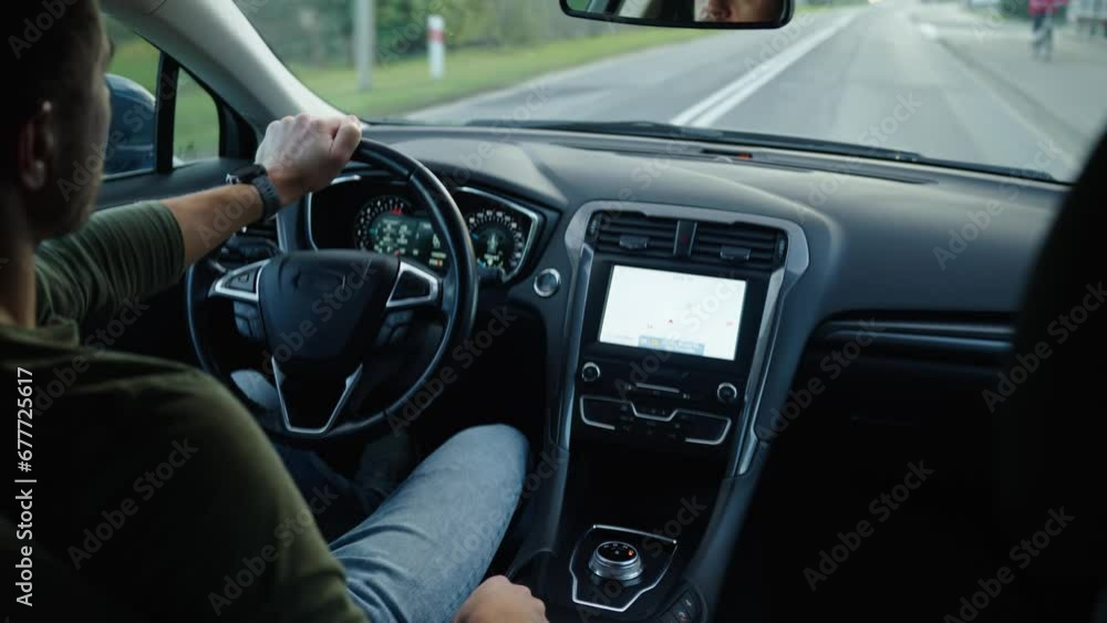 Man drives car on road in small city. Male driver driving auto, view from inside. Road trip Man drives car on road in small city. Male driver driving auto, view from inside. Road trip