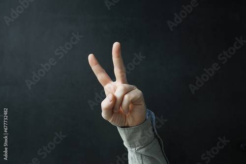 Male hands on a gray background. Finger gestures. Gesticulation with hands.