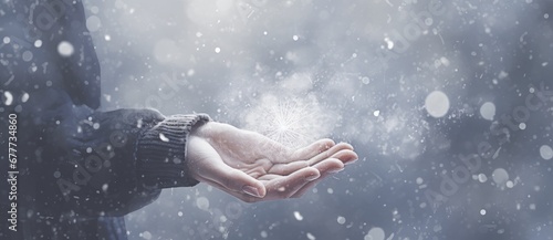  a person holding out their hand with a snowflake coming out of the palm of the palm of their hand. © Jevjenijs
