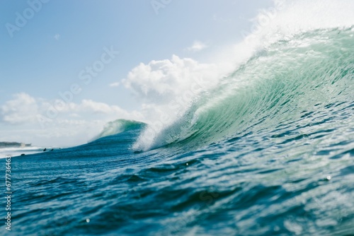 Beautiful shot of wave breaking in Carcavelos on a sunny day in Portugal