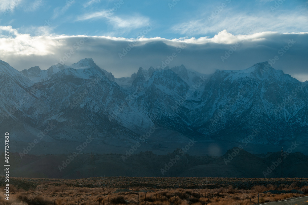 The towering mountains of the Sierra Nevada form a backdrop of the road to Lone Pine, California.