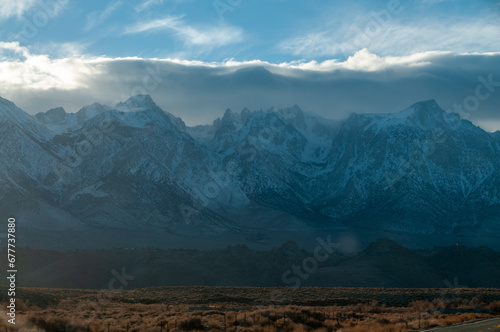 The towering mountains of the Sierra Nevada form a backdrop of the road to Lone Pine  California.
