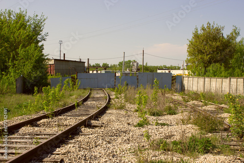 The railway tracks approach the enterprise.