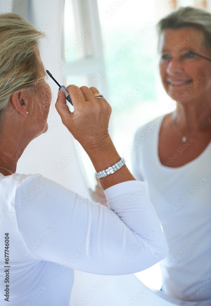 Obraz premium Senior woman, mascara and mirror in home with smile, thinking and beauty to start morning in retirement. Elderly person, makeup and brush for eyelash, reflection and happy in bathroom for cosmetics