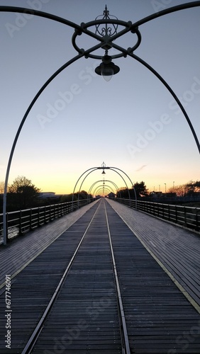 Scenic view of a wooden bridge during sunset